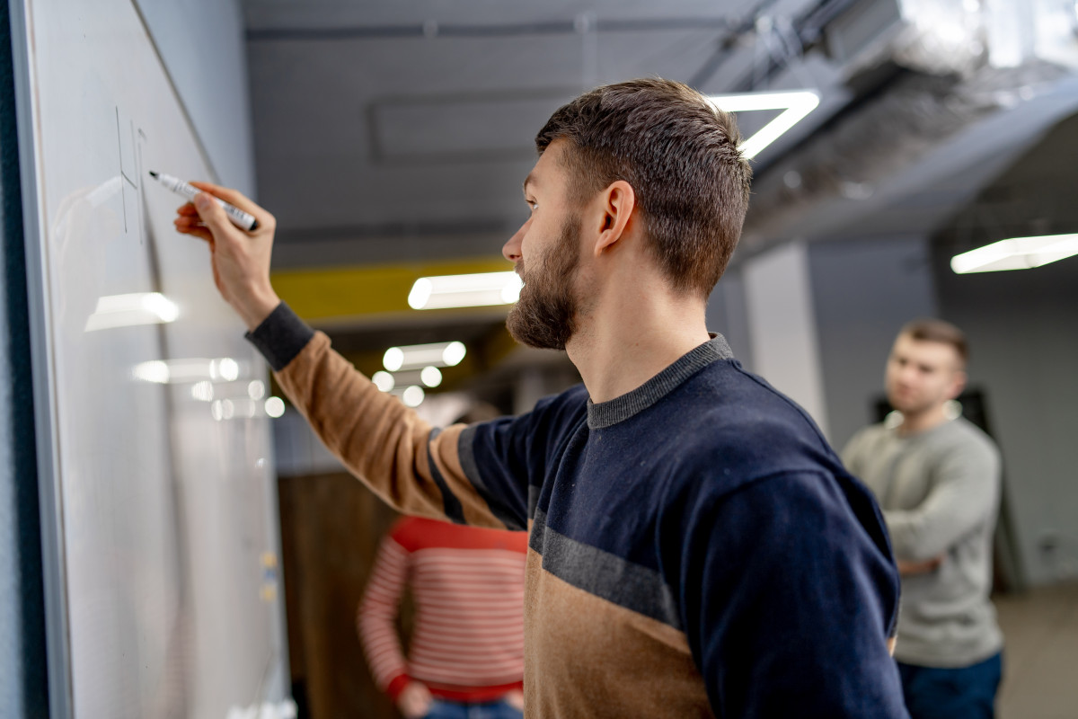 Junger Mann an einem Whiteboard