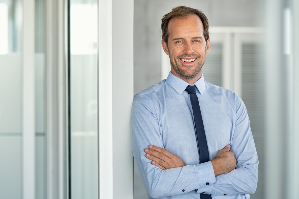 Mann im Hemd angelehnt an eine Wand